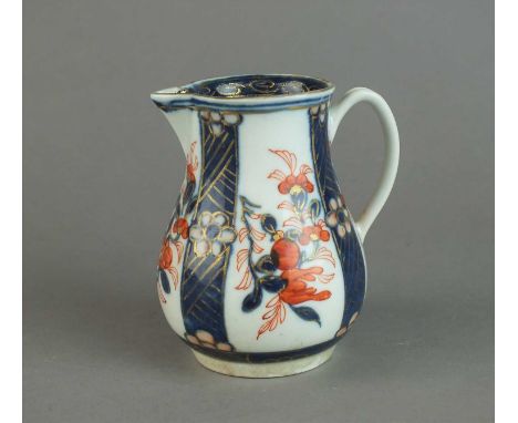 A Worcester sparrow beak jug circa 1770 painted with an Imari panelled pattern with plant scrolls and blue border to inside r