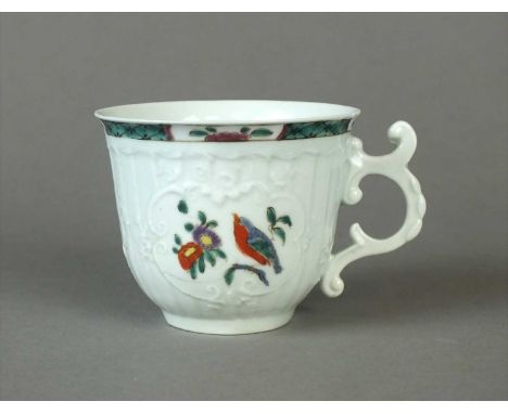 An early Worcester coffee cup circa 1754, of bell shape with an elaborately moulded scroll and husk handle with a high curled