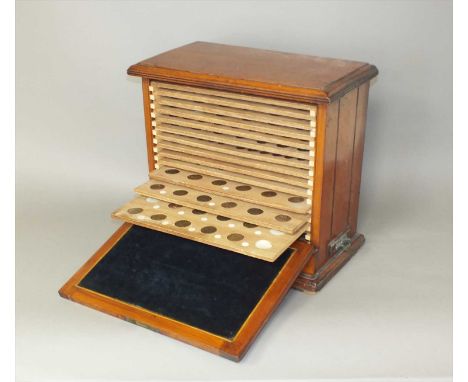 A mahogany fourteen tray coin cabinet, containing a collection of Guernsey and Jersey copper and bronze coinage, from 1830 (a