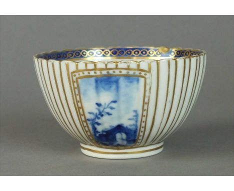 A rare Caughley tea bowl in the 'Bright Landscapes I' pattern circa 1788-93 painted in bright blue with three exterior panels