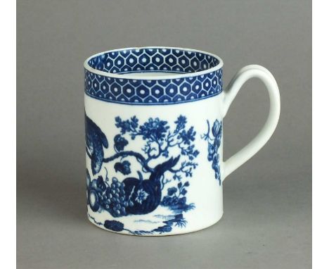 A Worcester 'Parrot Pecking Fruit' mug circa 1770-85 of cylindrical form, transfer-printed in underglaze blue below a broad c