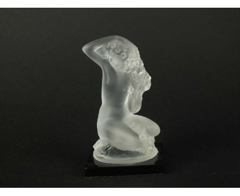 A small Lalique Crystal model of "Floreal" post-war modelled nude, seated with flowing hair, on square plinth base, paper lab