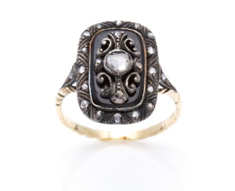 AN ANTIQUE DIAMOND DRESS RING in yellow gold and silver, set with a central rose cut diamond within a scrolling surround furt