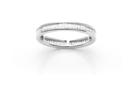 A DIAMOND ETERNITY RING in 18ct white gold, comprising a single row of baguette cut diamonds, stamped K18, size O / 7, 2.75g.