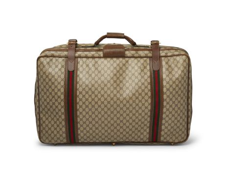 Featuring maker's monogram coated canvas exterior, brown leather trim, with green and red canvas strap work, a rigid leather 