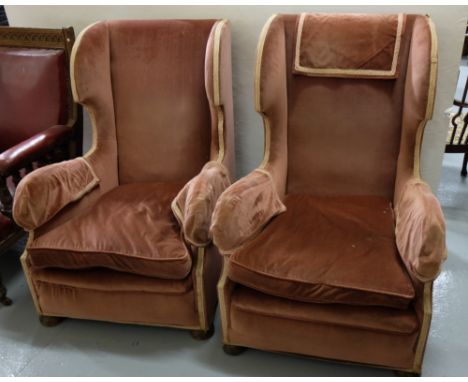 Matching Pair of High Wingback Armchairs, covered with pink velour fabric, button feet