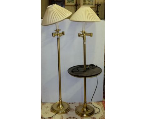 Pair of modern brass adjustable electric standard lamps with cream shades (1 with mahogany shelf), each 56”h