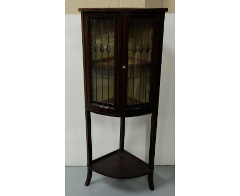 Early 20th C Corner Cabinet, inlaid with satinwood, the two leaded glass doors with green inserts, enclosing 1 shelf, on sabr