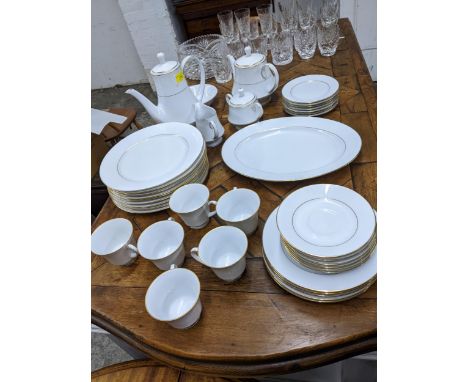 Glasses to include Champagne flutes tumblers and a bowl and a Noritake white glazed dinner and tea service decorated with a g