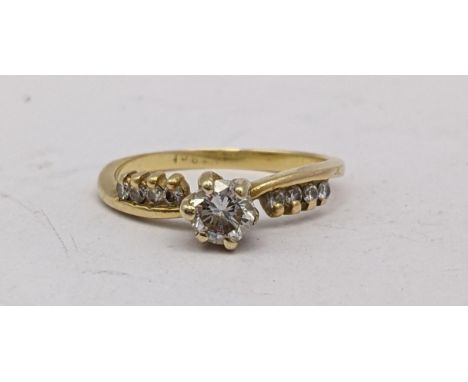 An 18ct gold ring set with a diamond approx 0.25ct and four diamonds to each shoulderLocation: 
