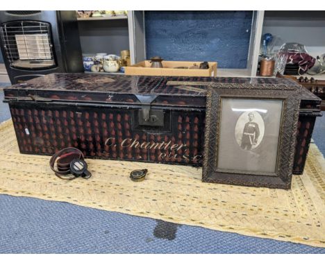 A military metal trunk signed C. Chantler, a Lieutenant in the Royal Army Service Corps and having various stickers including