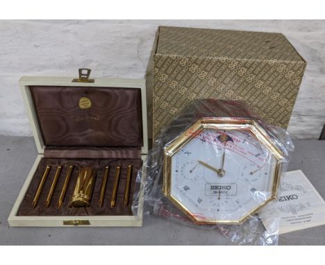 An Italian gold plated olive fork set and a Seiko quartz clockLocation: 