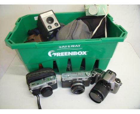 Box of assorted cameras including a Canon Eos 3000 N, a 3D stereo camera, a Minolta Rangefinder style camera, Kodak boxed Bro