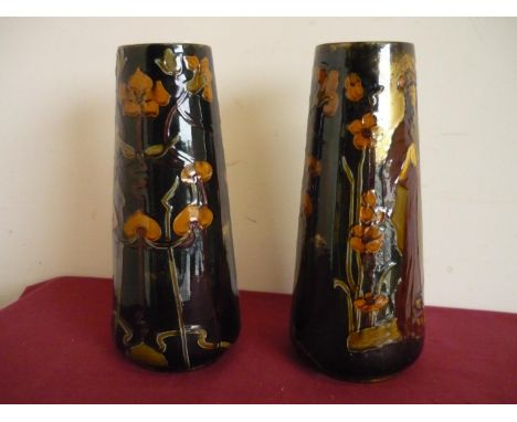 Pair of Art Nouveau ceramic vases of tapering form, depicting semi clad ladies (height 37cm) 