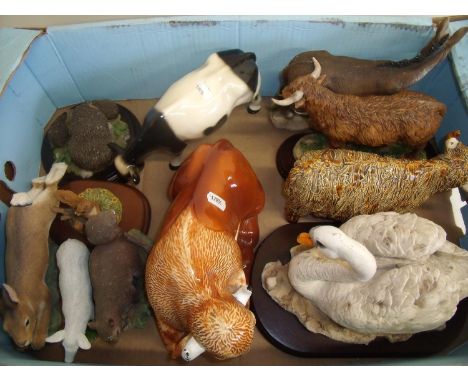 Selection of ceramic animals including cows, wildlife figures and a swan 