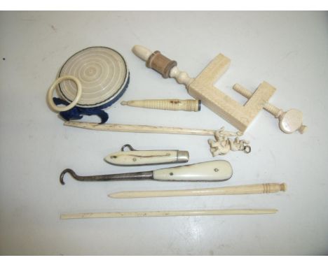 Collection of 19th/20th C bone and ivory items including a carved ivory clamp, pin cushion, various button hooks etc 