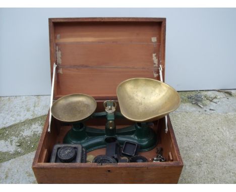 Wooden box containing a set of scales, including weights 