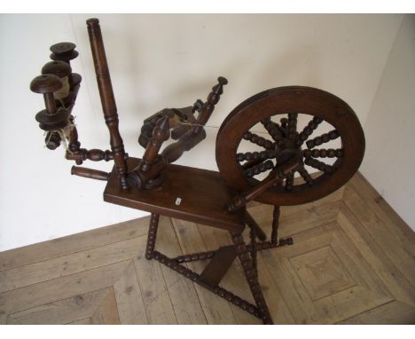 Oak spinning wheel on bobbin turn supports with various spools 