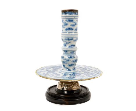 Chinese blue and white candlestick with wide drip tray, Qing Dyansty, painted with dragons chasing a flaming pearl, on a whit