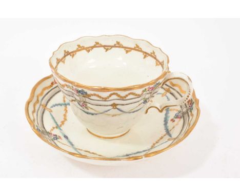 Caughley ogee shaped large breakfast cup and saucer, circa 1790, decorated in enamels and gilt with swags, the saucer 15cm di