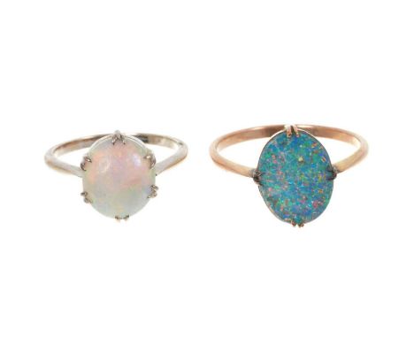 Two 9ct gold set opal rings, one with an oval opal cabochon in 9ct white gold setting, size N½ and an opal doublet in 9ct yel
