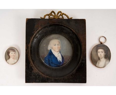 Three 18th portrait miniatures on ivory, the largest a portrait of a gentleman in blue coat, circular, 7cm diameter in ebonis