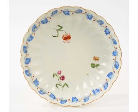 Unusual Worcester fluted saucer dish, circa 1772, London decorated with three flowers, within a dry blue enamel band of leave