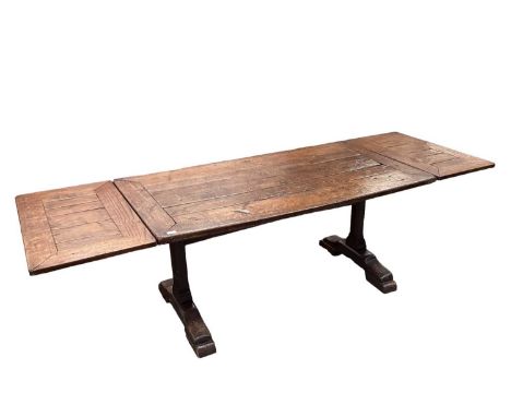 17th century oak trestle refectory table, with plank top on standard ends and sledge supports united by central stretcher, 16