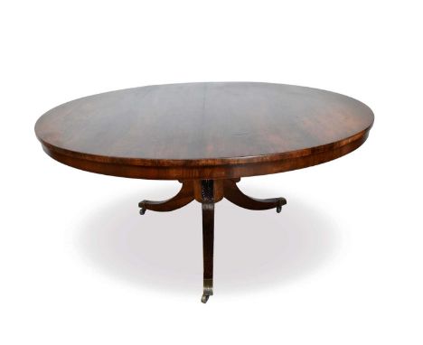 George IV rosewood and simulated rosewood pedestal dining table, with circular tilt top on bulbous column and hipped splayed 