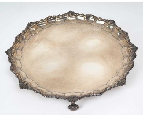 1930s silver salver of octagonal form, with scroll and shell border, on four scroll feet (Sheffield 1932) Harrison Brothers &