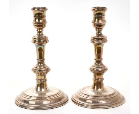 Pair of contemporary silver candle sticks, with knopped stems and integral candleholders, on circular bases (filled), in the 