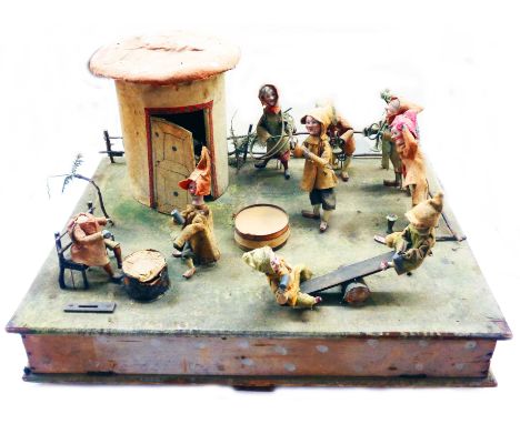 A large Victorian penny-in-the-slot musical automaton with diorama depicting ten pixie figures of wooden construction with po