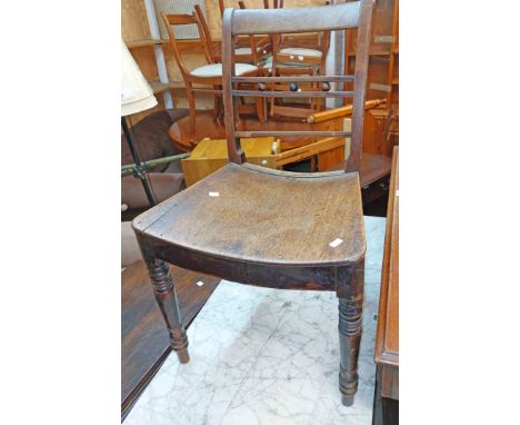 A Victorian mahogany ladder back standard chair with wide curved seat, set on ring turned front supports - one splat detached