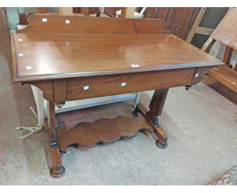 A 1.12m Victorian mahogany side table with low raised back and blind frieze drawer, set on shaped standard ends, undertier an