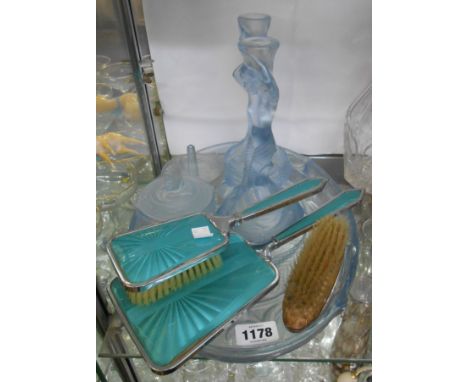 An Art Deco pressed glass part dressing table set with mermaid design comprising pair of candlesticks, trinket box, ring dish