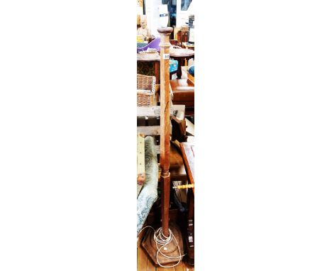 A vintage stripped mahogany standard lamp with faceted pillar and circular base
