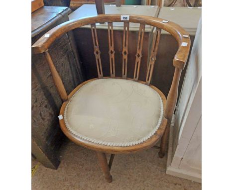 An Edwardian stained beech framed bow elbow chair with upholstered seat panel, set on an X-stretcher base