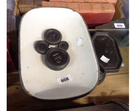 A set of black painted iron kitchen scales and weights