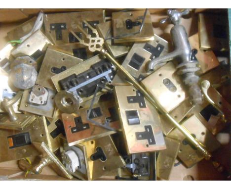 A box containing a quantity of metal items, including brass fronted light switches, taps etc.