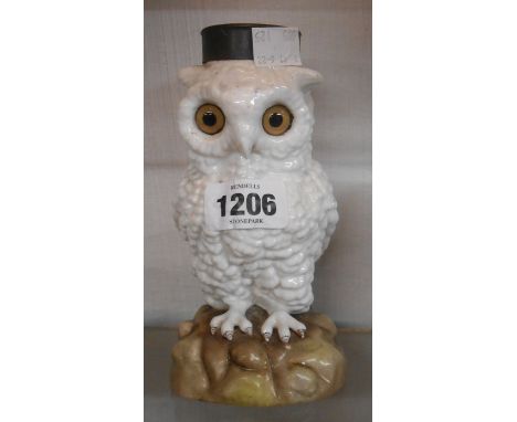 A late 19th Century German porcelain oil lamp base modelled as a seated owl with inset glass eyes and brass oil lamp fitting 