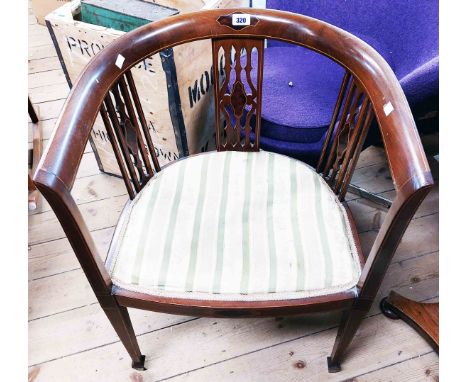 An Edwardian walnut and strung bow chair with decorative pierced splats and upholstered seat panel, set on square tapered fro