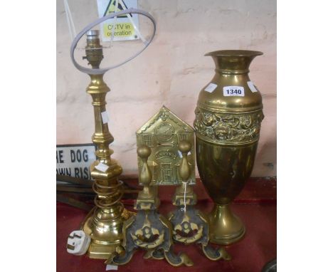 A quantity of old brassware comprising candlestick form table lamp, antique brass fronted money bank, a pair of firedogs and 