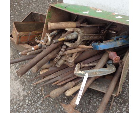 A lawn mower grass collection box containing a collection of clamps and tools