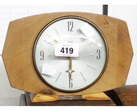 A vintage wooden cased Smiths desk timepiece with silvered dial and eight day floating balance movement