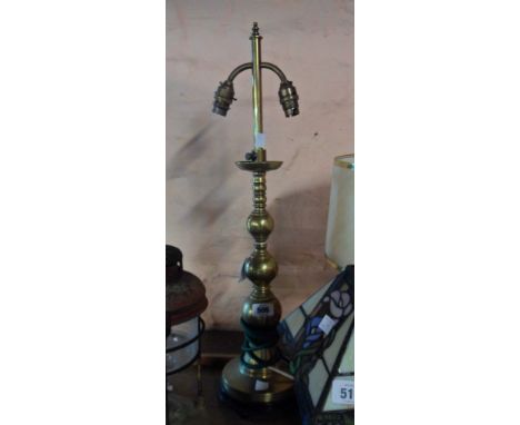 An old brass adjustable table lamp, set on wooden base