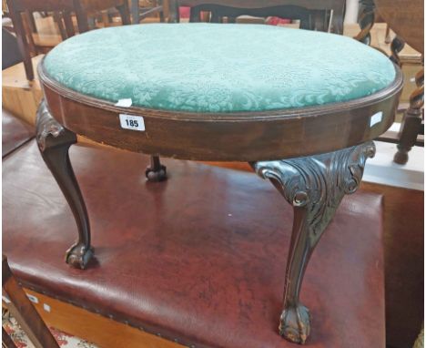 An old mahogany dressing stool with oval drop-in seat panel, set on acanthus cabriole legs with claw and ball feet