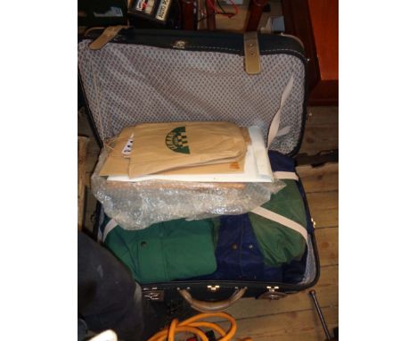 A suitcase containing a quantity of Morgan car collectables including coats, framed cigarette cards, calendars, etc.