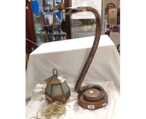 An Art Deco copper table lamp of hanging lantern form, the stand modelled as rearing serpent with inset banded agate eyes, se