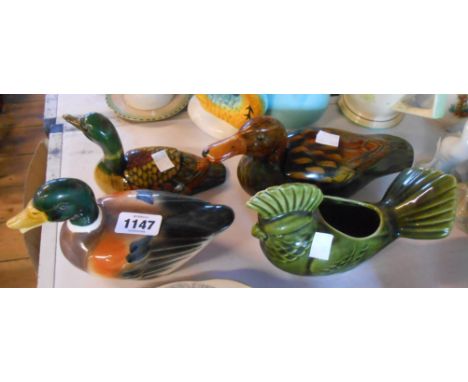 Three ceramic ducks and a similar parrot
