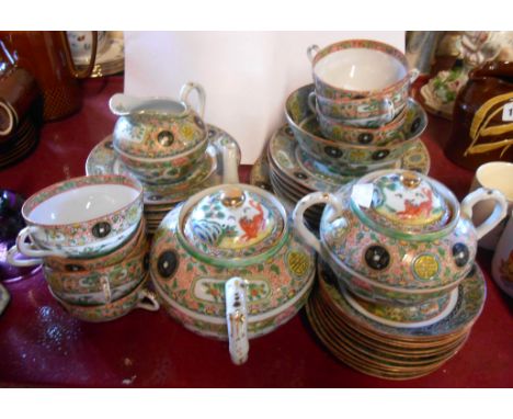 An early 20th Century Chinese eggshell porcelain tea set comprising teapot, sucrier, milk and sugar, nine trios, two bread an